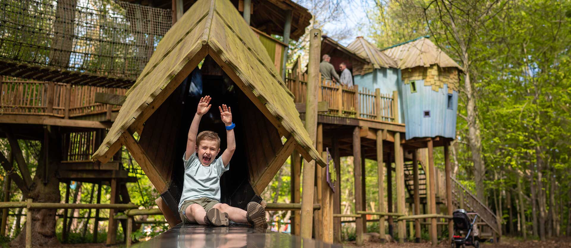A boy slides down the slide at BeWILDerville in BeWILDerwood Norfolk