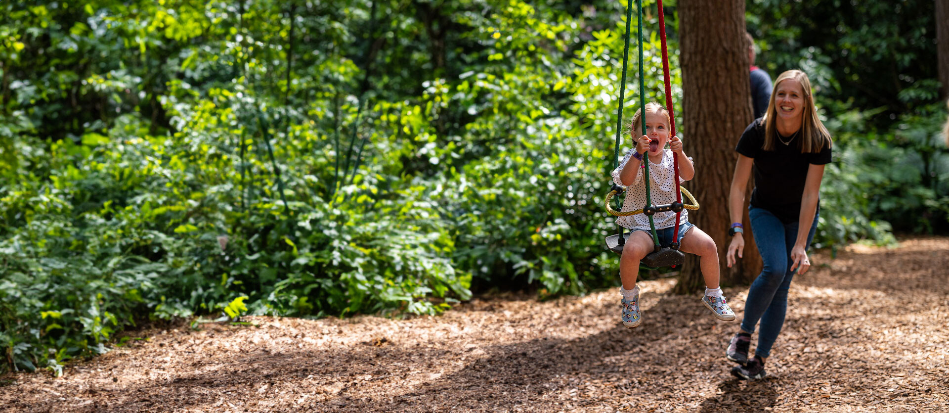A mother and child play on the Twiggle Whizzers at BeWILDerwood