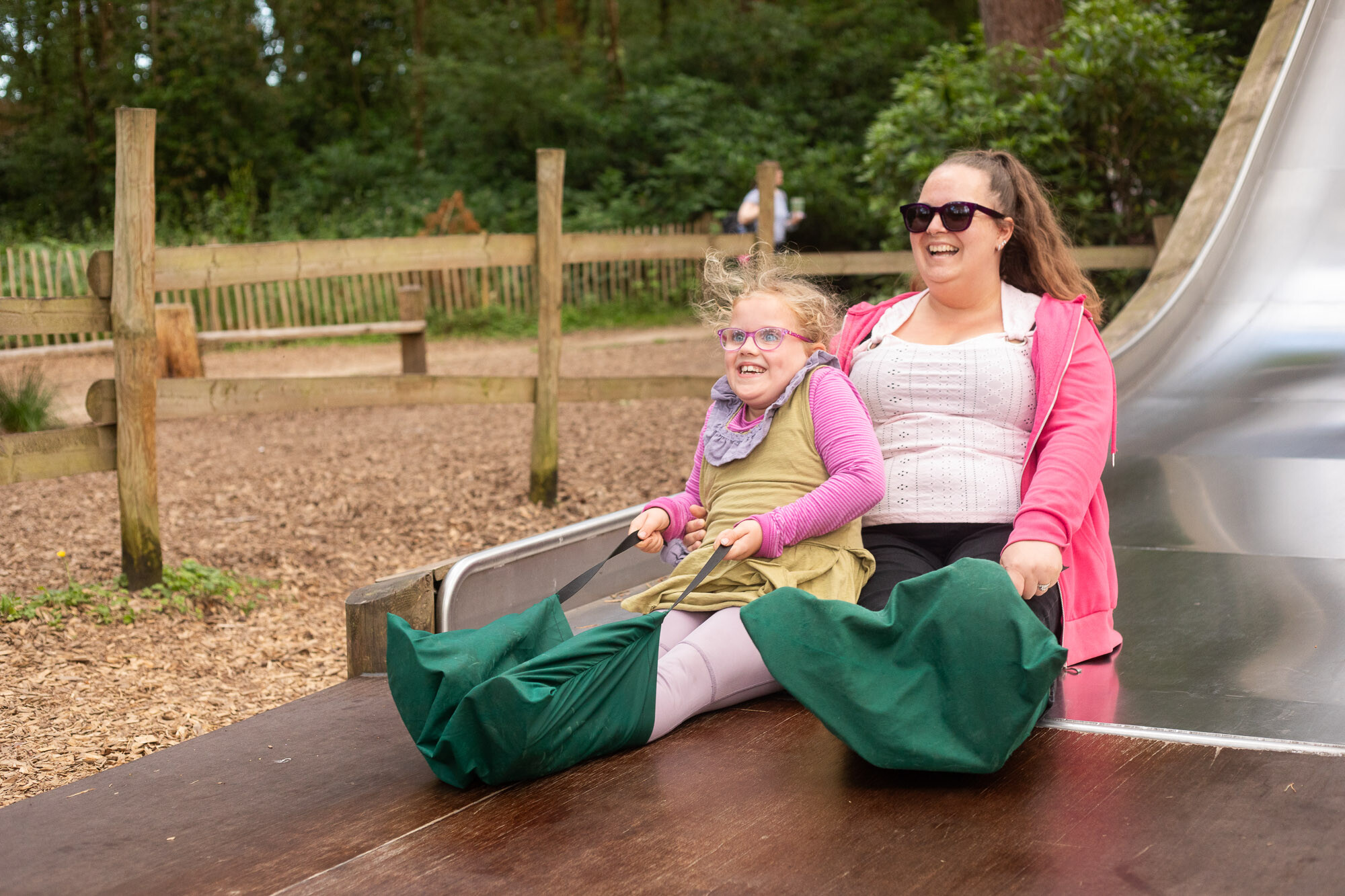 Mum and daughter going down slide